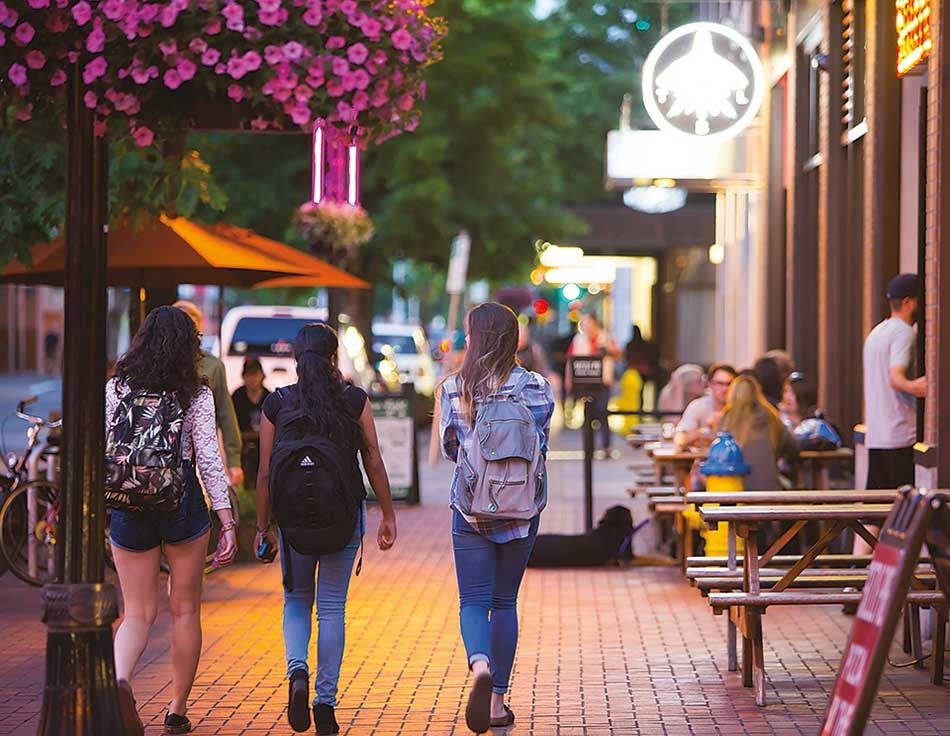 Eugene, Oregon People walking down the sidewalk next to some shops in downtown Eugene